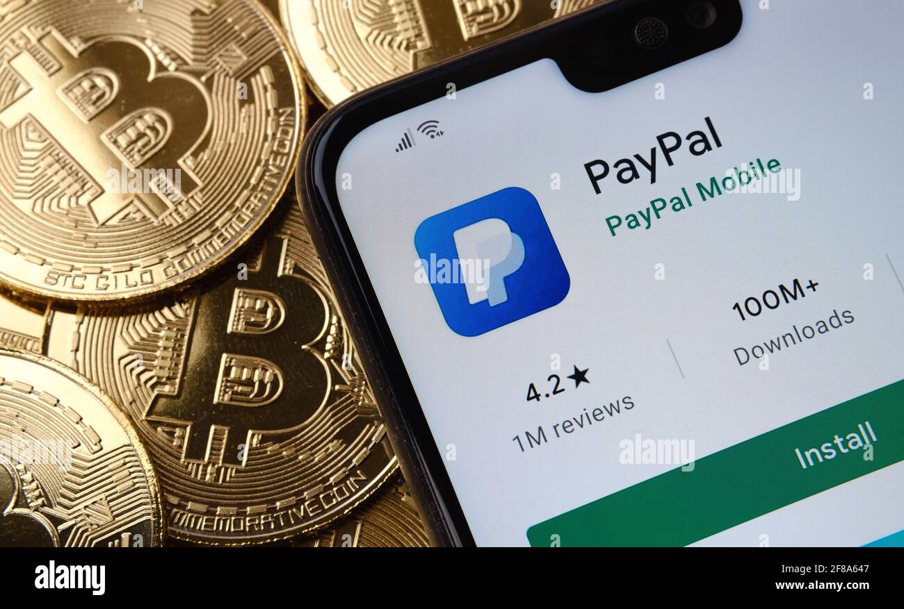 Paypal app seen on the smartphone screen placed on top bitcoin coins pile.  Concept. Stafford, United Kingdom, April 12, 2021 Stock Photo - Alamy