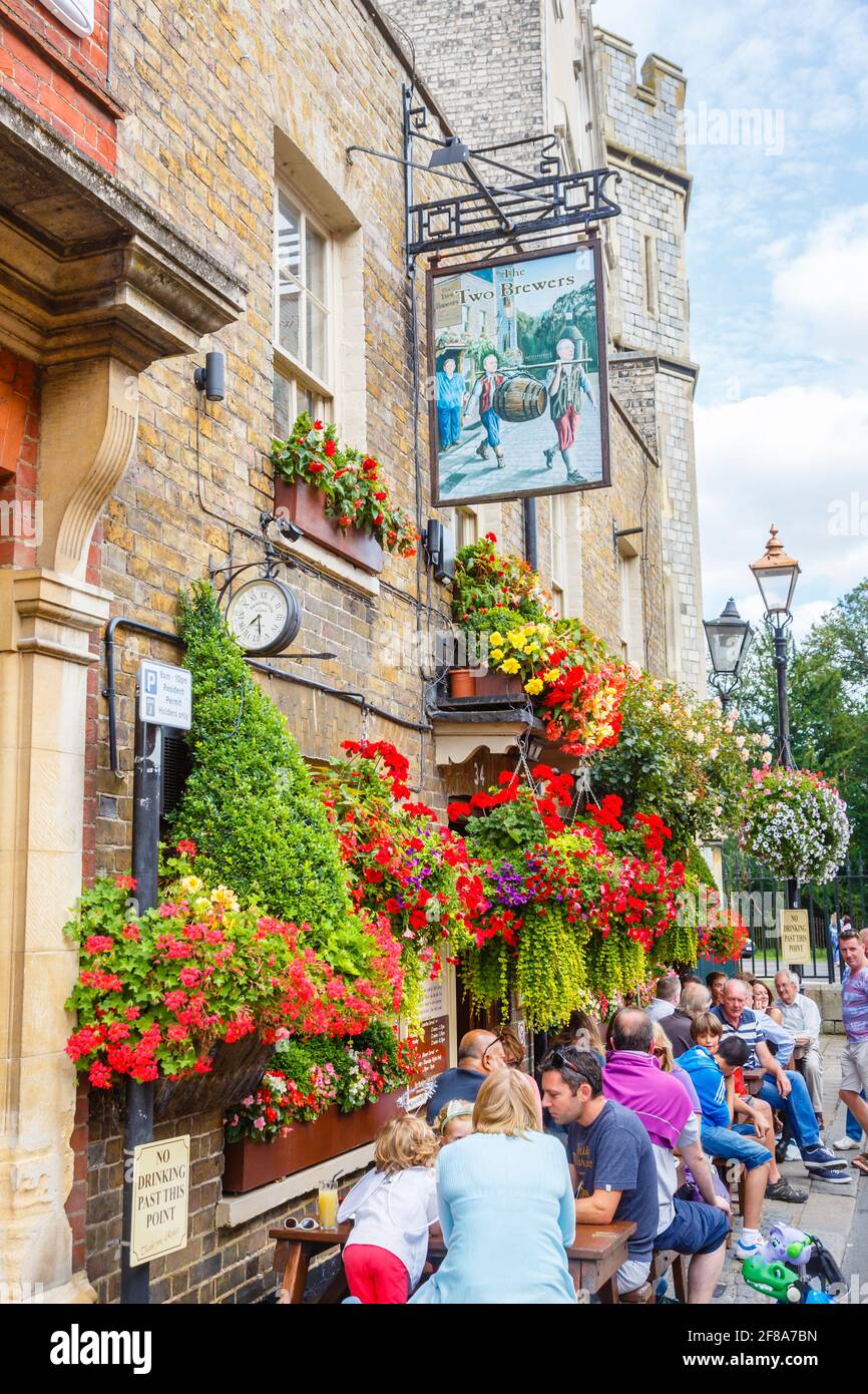 The Two Brewers pub in the town centre of Windsor, Berkshire, south-east England with customers drinking outside on the roadside on a sunny day Stock Photo