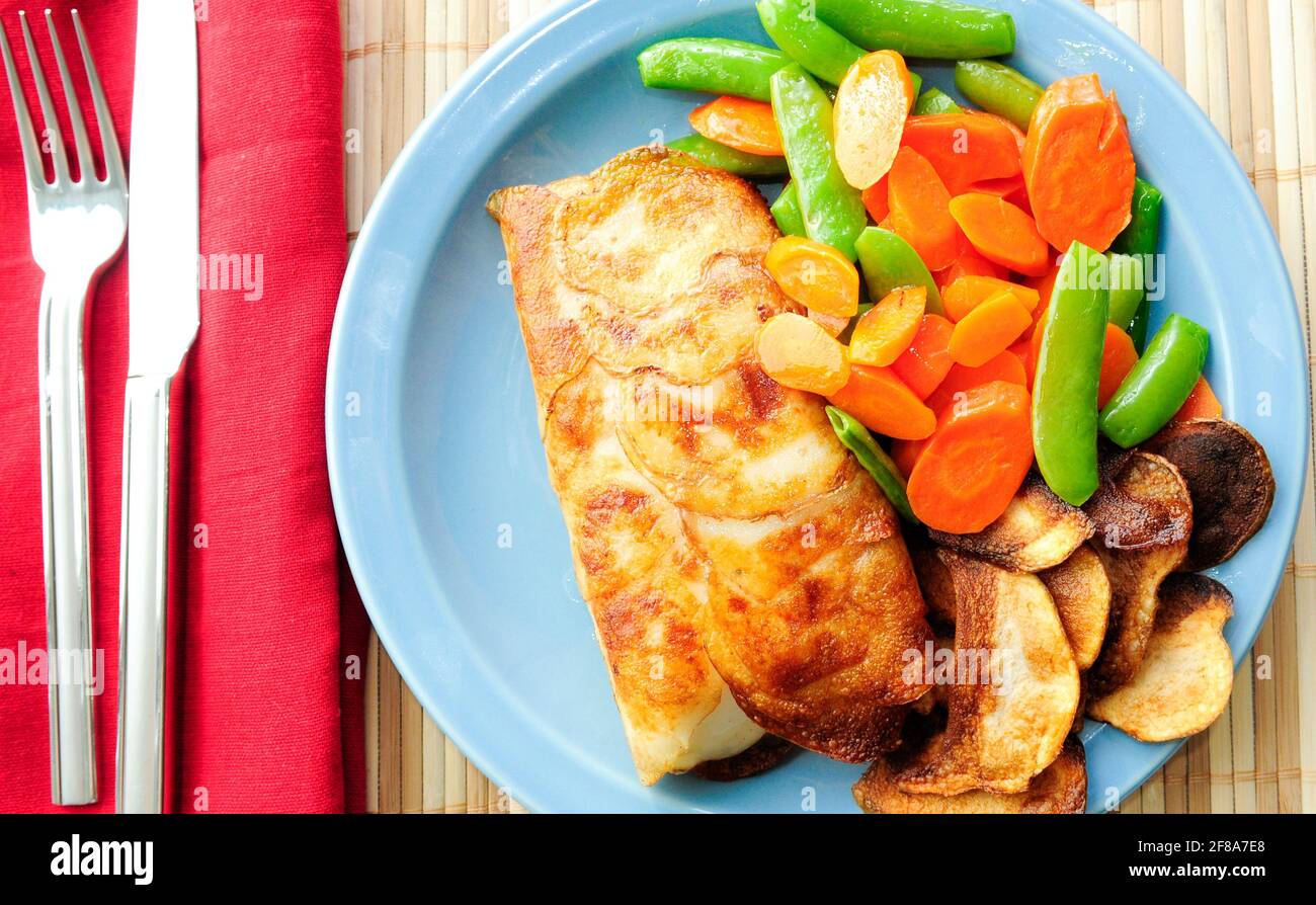 potato wrapped halibut fish fillets Stock Photo Alamy
