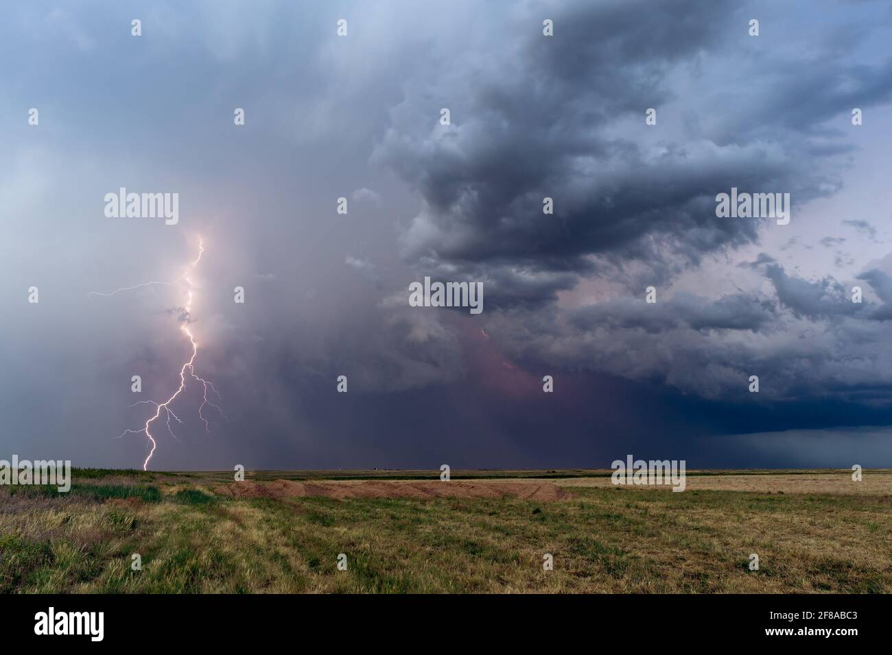 Great Plains landscape with a  thunderstorm and lightning strike near Lamar, Colorado Stock Photo