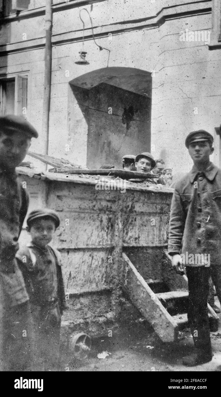 Refuse cart in courtyard of crowded Jewish tenement in Warsaw. This is the only outlet for the refuse of the fifty-four families which live in this town, October 1919 Stock Photo