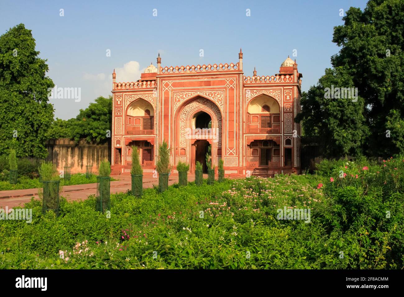 Red entrance building at Itmad-Ud-Daulah or baby Taj Mahal in Agra India against blue sky Stock Photo