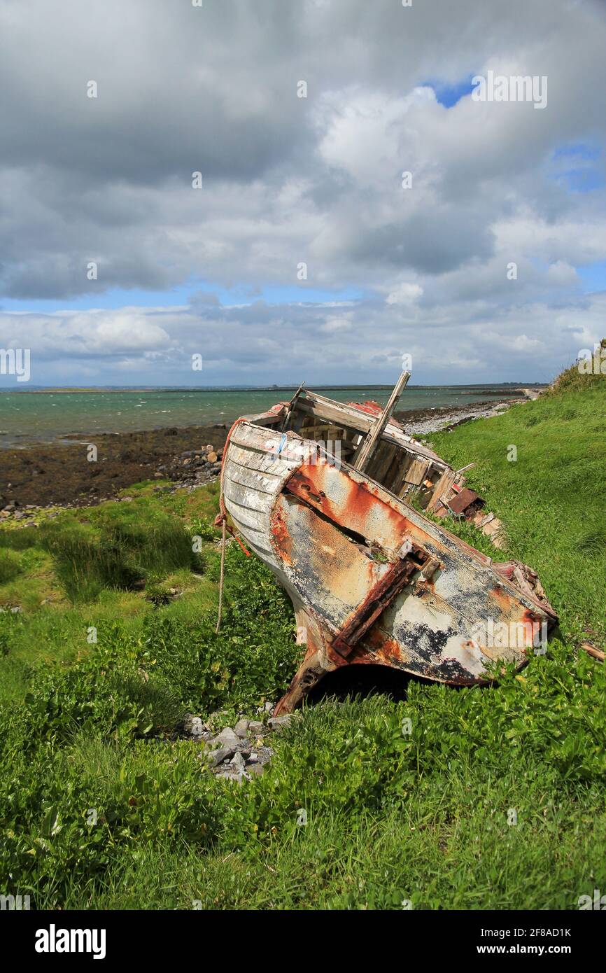 Rusty wrecked wooden boat abandoned on the coast of Ireland Stock Photo