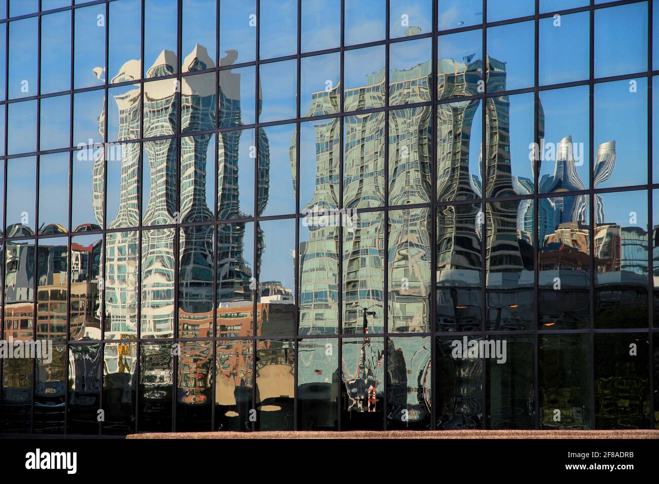 Milwaukee Skyline Reflected in Mirrored Building with Blue Sky Stock Photo