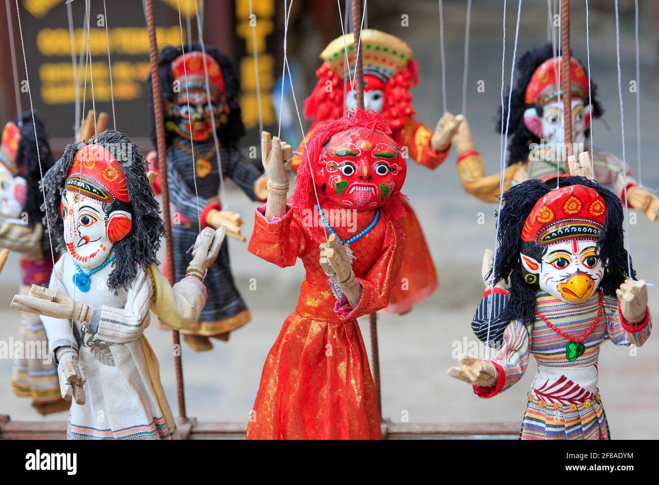 Traditional colorful carved wood puppets at market in Patan, Nepal Stock Photo