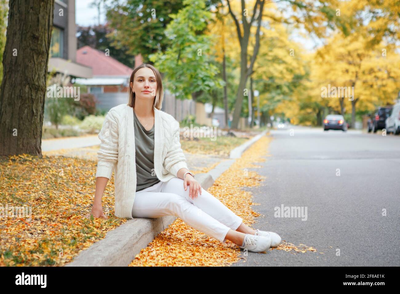 Beautiful Middle Age Caucasian Woman With Short Hair Sitting In Autumn Fall Street Outdoor Woman With Short Haircut In Casual Clothes In Park Stock Photo Alamy