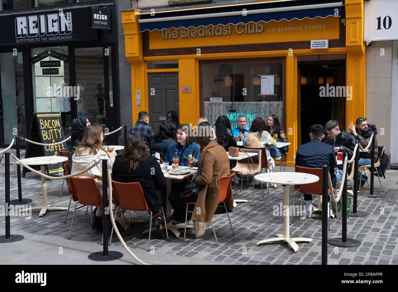 London, Britain. 12th Apr, 2021. People dine at an outdoor restaurant