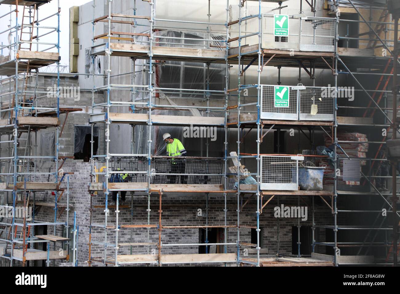 Dublin. 13th Apr, 2021. Workers are busy at a reopened residential construction site in Dublin, Ireland, April 12, 2021. Ireland on Monday started to ease some of its COVID-19 restrictions as scheduled. People are allowed to travel freely within the county where they live or within 20 kilometers from their home, with outdoor gatherings permitted for no more than two households, in-classroom education for all primary and secondary school students resumed, and all residential construction projects reopened. Credit: Xinhua/Alamy Live News Stock Photo
