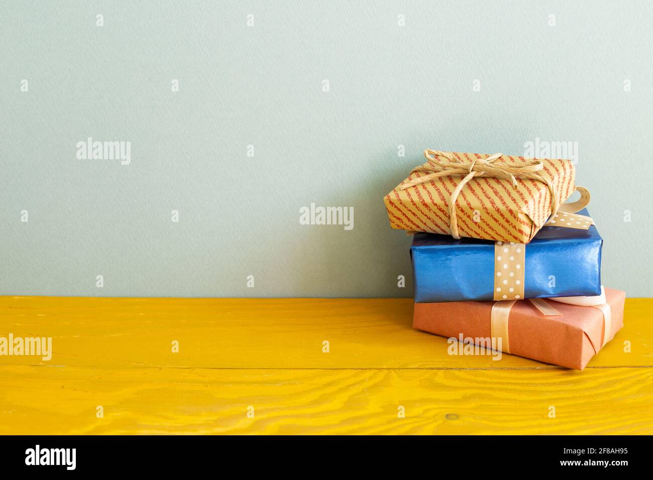 Gift boxes on wooden table. blue background Stock Photo