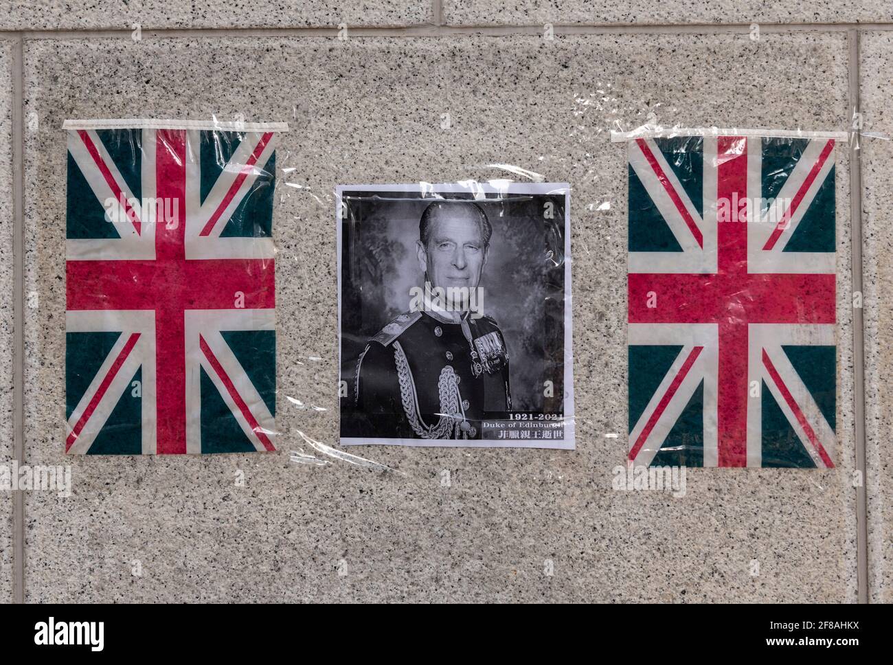 HONG KONG,HONG KONG SAR,CHINA: APRIL 13th 2021. Flowers and tributes to Prince Philip, Duke of Edinburgh placed outside The British Consulate-General offices in Admiralty Hong Kong. The 99 year old husband of Queen Elizabeth II passed away on 9 April 2021 at Windsor Castle.As an former British colony, many Hong Kong citizens still have fond memories for their British connections. Alamy Live news/Jayne Russell Stock Photo