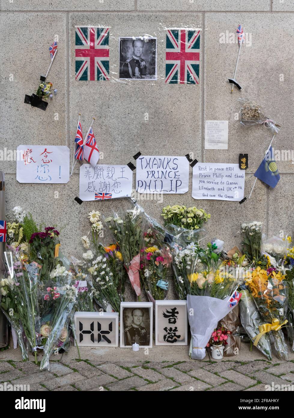 HONG KONG,HONG KONG SAR,CHINA: APRIL 13th 2021. Flowers and tributes to Prince Philip, Duke of Edinburgh placed outside The British Consulate-General offices in Admiralty Hong Kong. The 99 year old husband of Queen Elizabeth II passed away on 9 April 2021 at Windsor Castle.As an former British colony, many Hong Kong citizens still have fond memories for their British connections. Alamy Live news/Jayne Russell Stock Photo