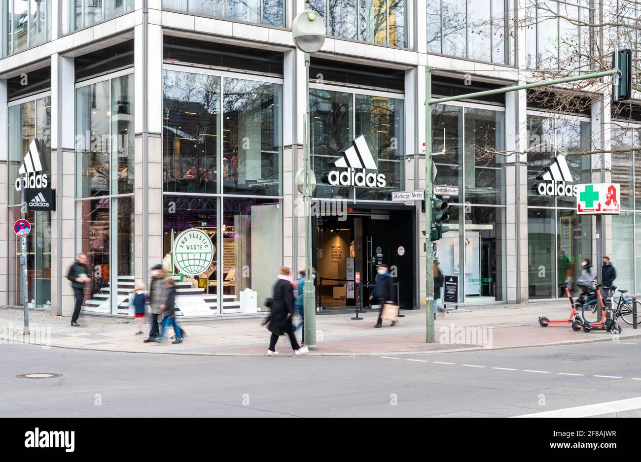 Berlin, Germany. 12th Apr, 2021. People walk past the Adidas store on  Tauentzienstrasse. Big brand manufacturers like Adidas, Miele and Co. are  increasingly bypassing retailers and selling directly to consumers. (shot  with