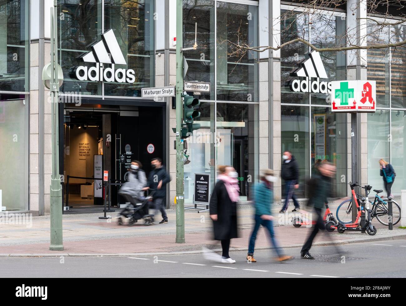 Berlin, Germany. 12th Apr, 2021. People walk past the Adidas store on  Tauentzienstrasse. Big brand manufacturers like Adidas, Miele and Co. are  increasingly bypassing retailers and selling directly to consumers. (shot  with