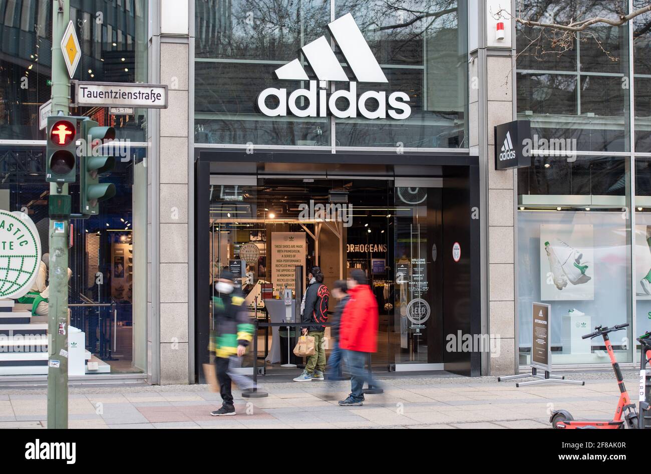 Berlin, Germany. 12th Apr, 2021. People walk past the Adidas store on  Tauentzienstrasse. Big brand manufacturers like Adidas, Miele and Co. are  increasingly bypassing retailers and selling directly to consumers. (shot  with