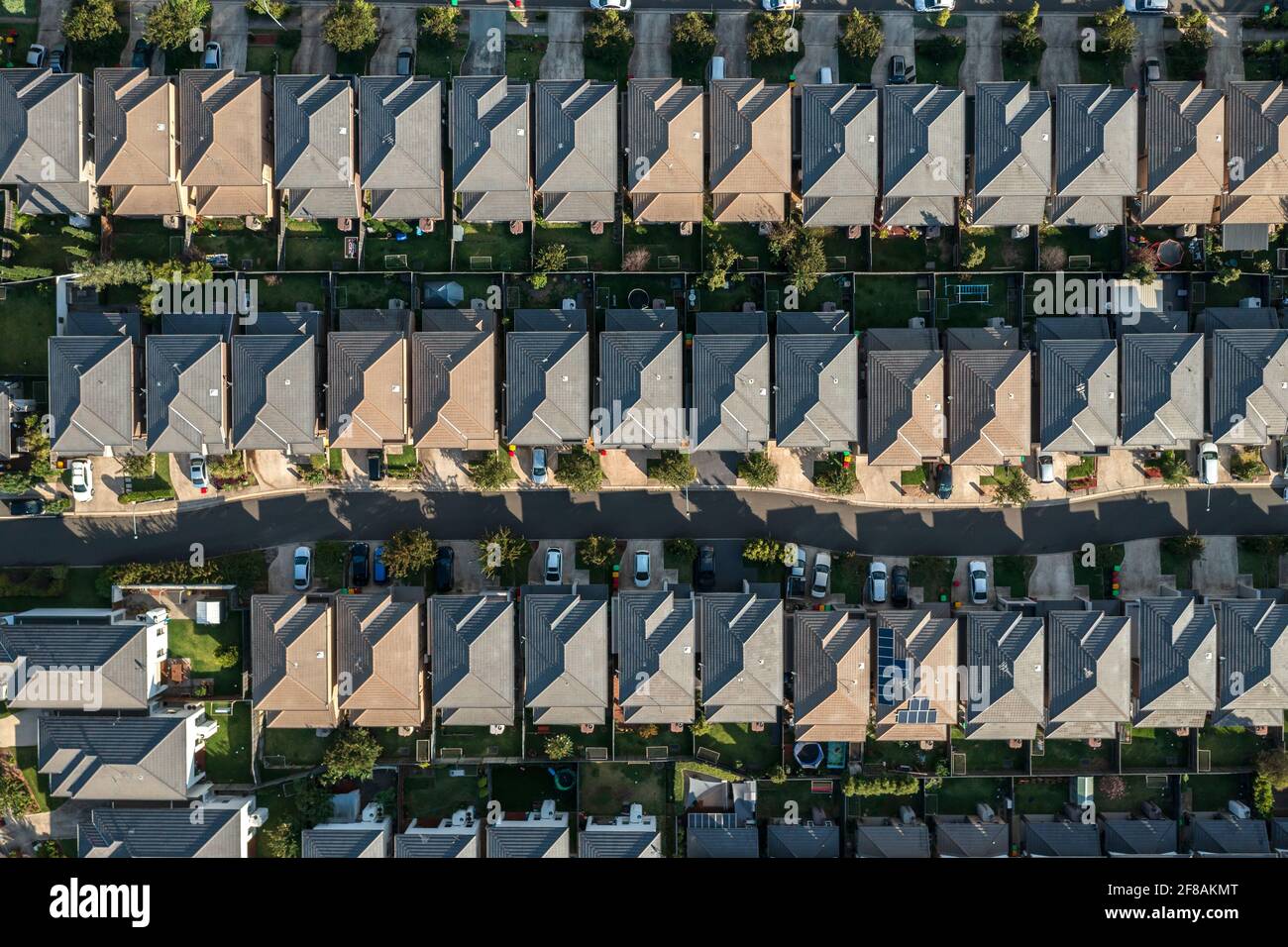Top down aerial view of houses tightly packed in rows with driveways and backyards. Sydney, Australia. Stock Photo