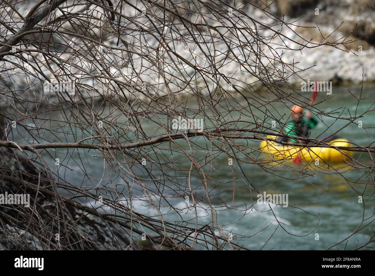 Rhine Gorge in Safiental in Switzerland in springtime with a rafter on the white water on the background paddling down the stream. Stock Photo