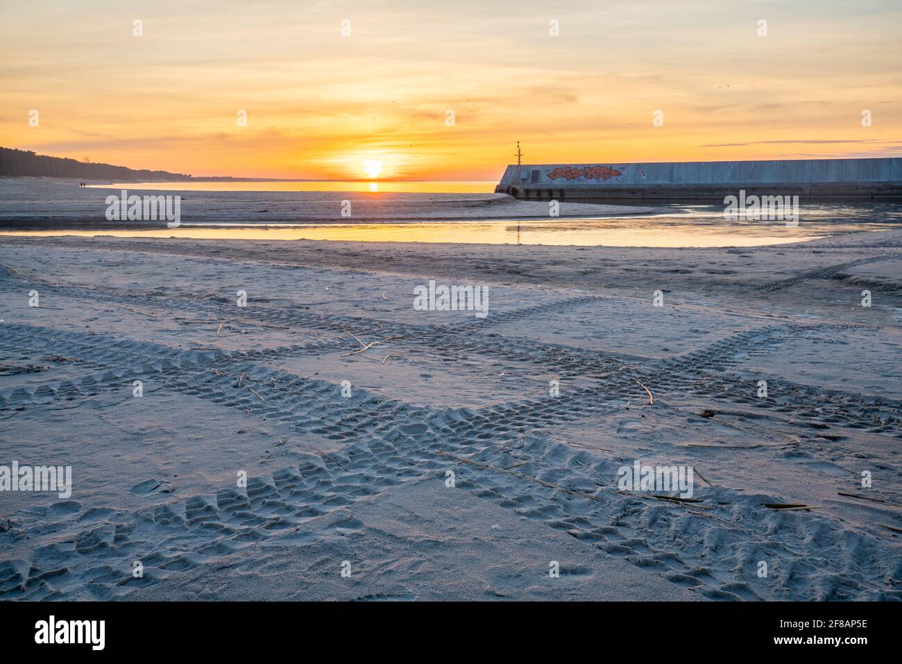Tire tracks of an off-road car driving on the beach Stock Photo