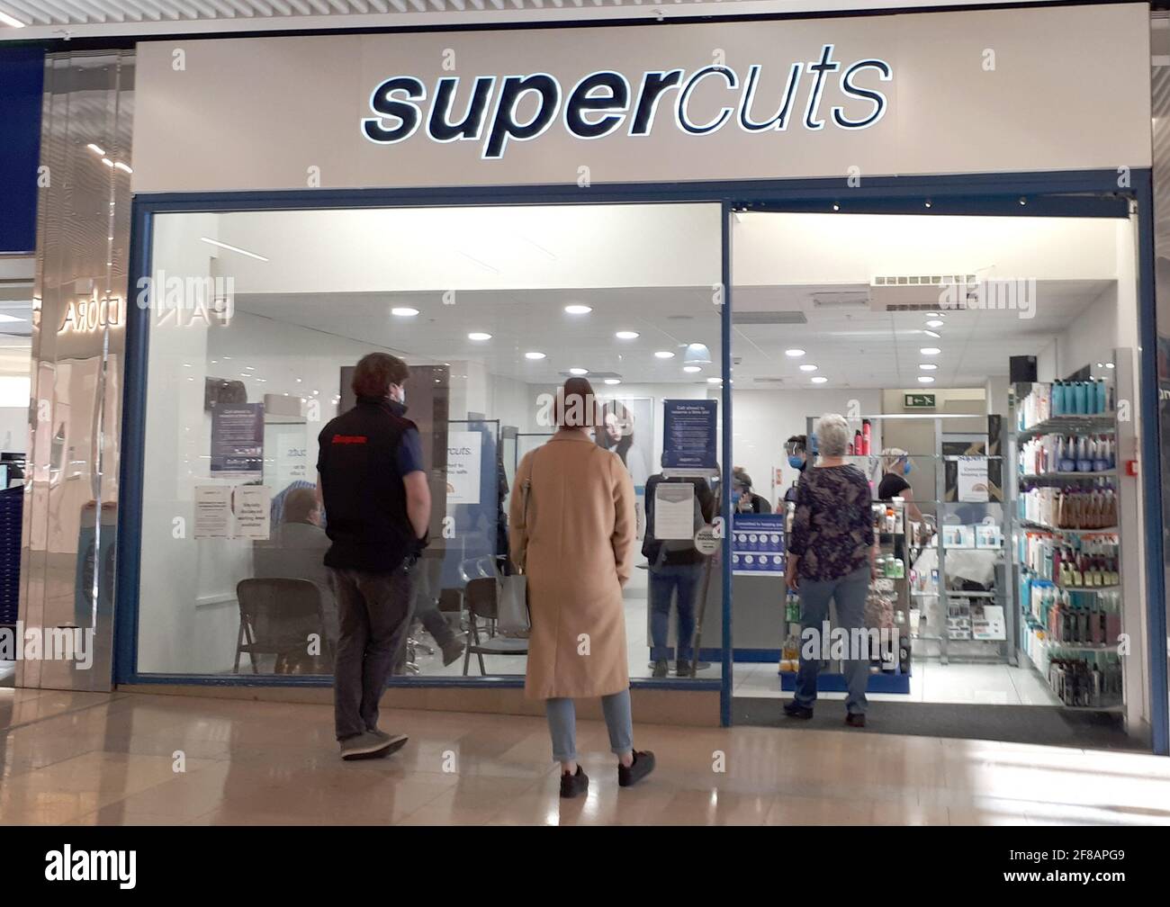 Peterborough Uk 12th Apr 2021 People Queue Outside The Supercuts Hairdresser In The Queensgate Centre In Peterborough City Centre This Morning As Non Essential Shops Pubs And Indoor Sports Venues Can Re Open Today Peterborough Uk 12th Apr 2021 People Queue Outside The Supercuts Hairdresser In The Queensgate Centre In Peterborough City Centre This Morning As Non Essential Shops Pubs And Indoor Sports Venues Can Re Open Today