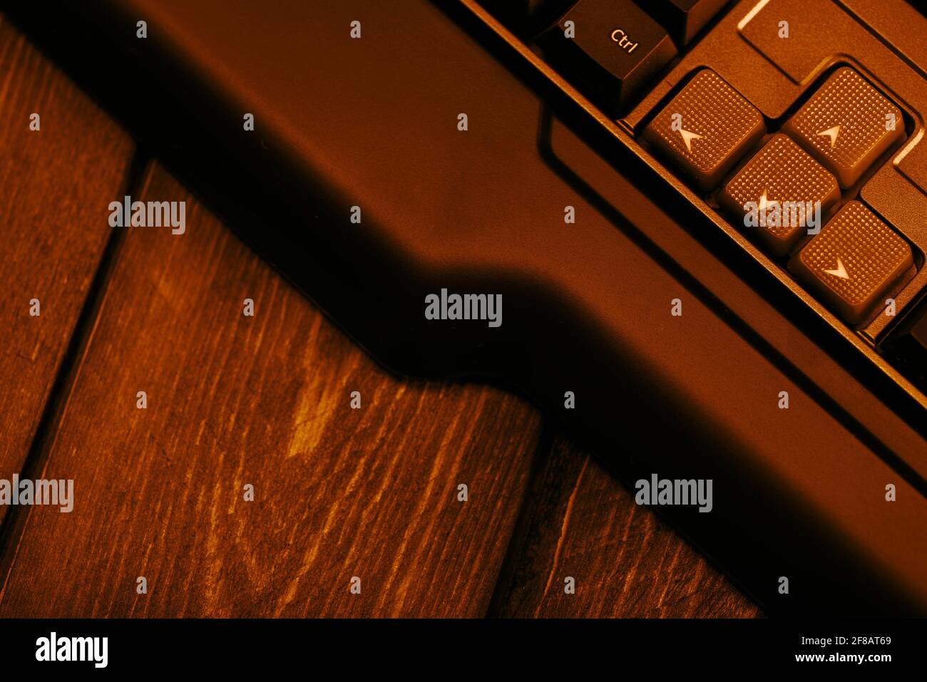 Gaming computer keyboard on a wooden table. Up and down buttons on a ...