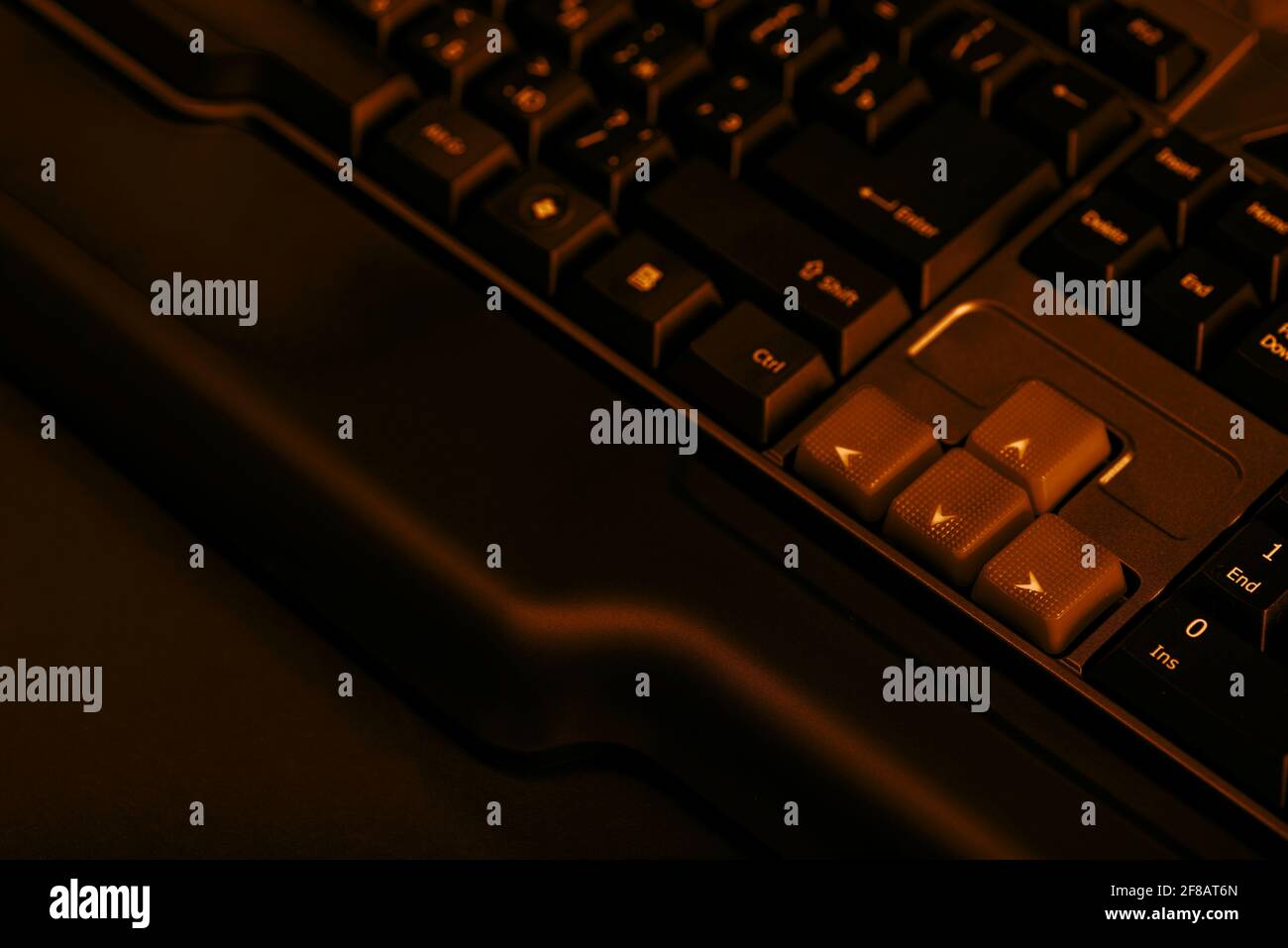 Gaming computer keyboard on a dark background. Up and down buttons on a computer keyboard. Stock Photo