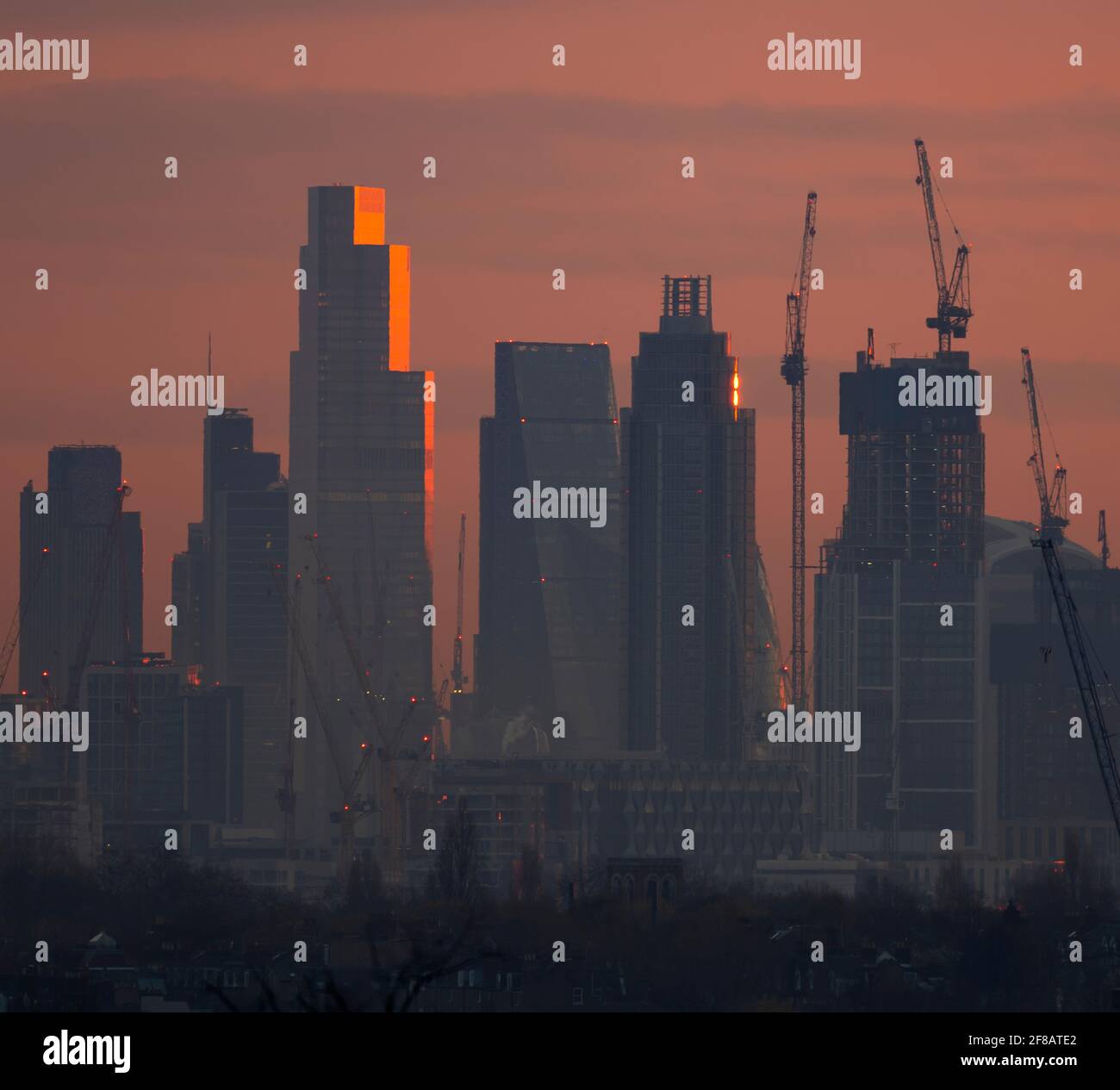 London, UK. 13 April 2021. Dawn breaks over central London skyscrapers with sunlight reflecting off the upper storeys of 22 Bishopsgate, the 62 storey, 912ft tall, office building in the City of London. Credit: Malcolm Park/Alamy Live News. Stock Photo