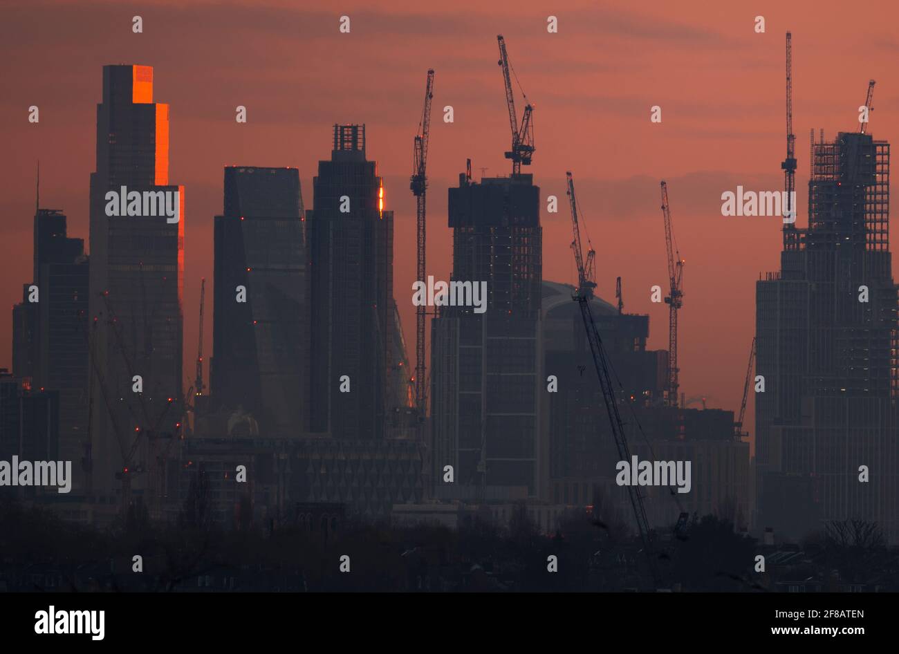 London, UK. 13 April 2021. Dawn breaks over central London skyscrapers with sunlight reflecting off the upper storeys of 22 Bishopsgate, the 62 storey, 912ft tall, office building in the City of London. Credit: Malcolm Park/Alamy Live News. Stock Photo