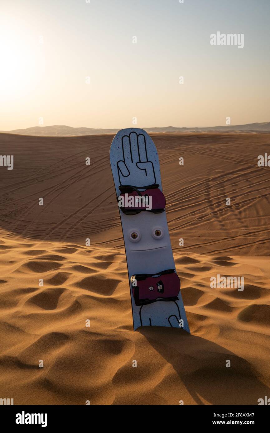 Desert safari tour in UAE. Snowboard used for sand boarding standing