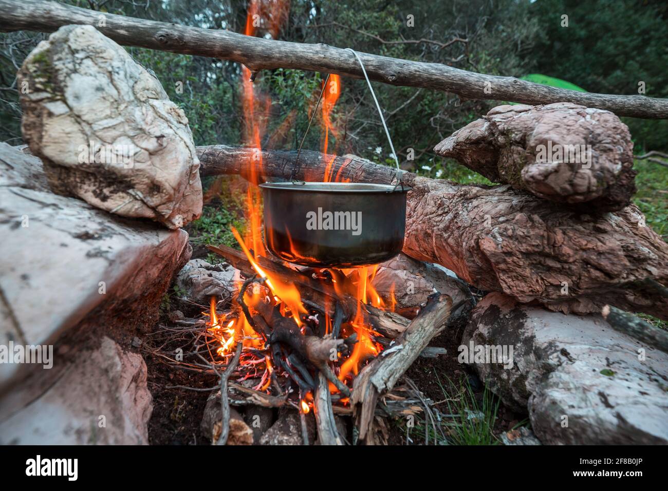 Camping kettle over burning campfire. Stock Photo