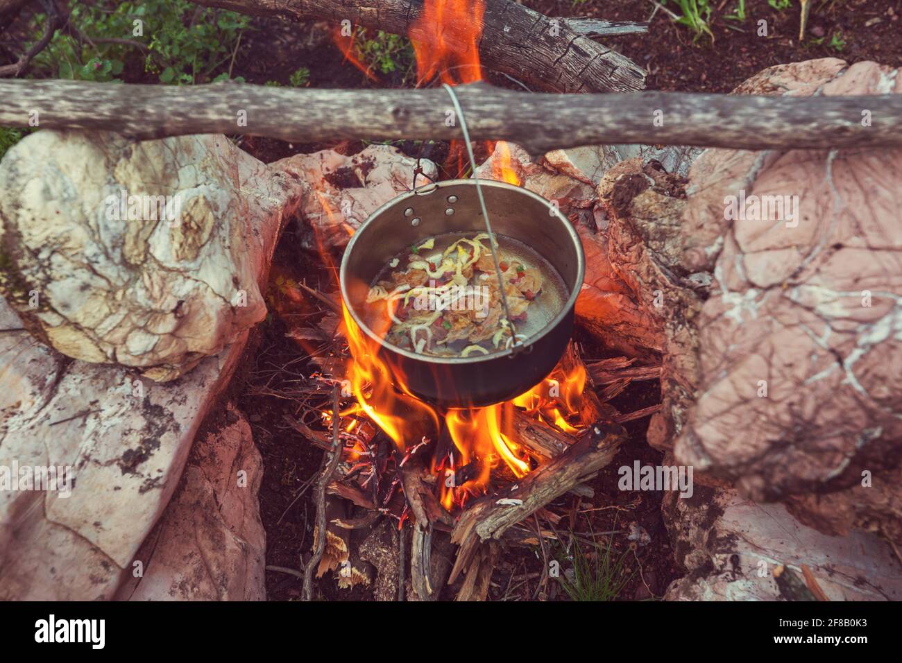 Touristic kettle on fire of burning campfire in camping in the hike ...