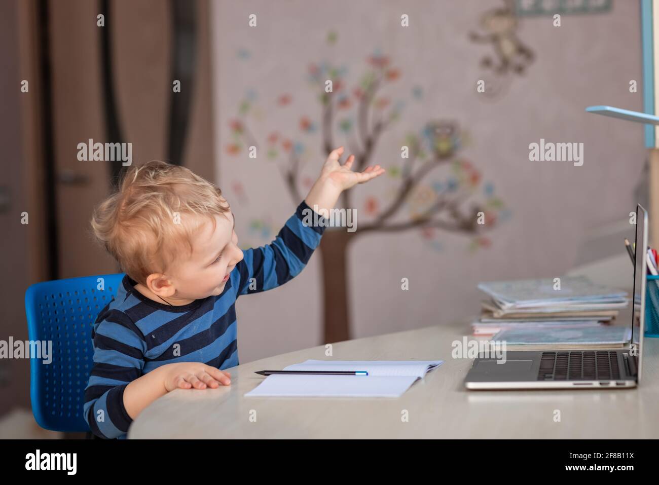 Cute baby boy having video class or video chat with grandparents. Quarantine isolation distance