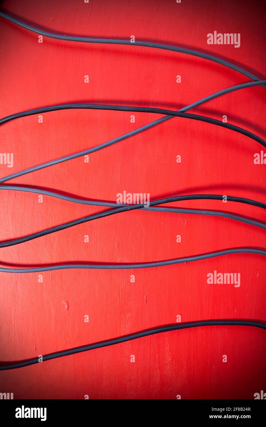 Black Cables  On Red Stock Photo