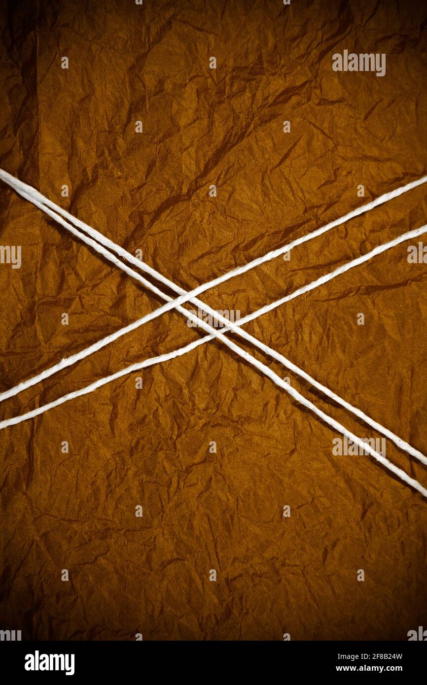 White String Bound and Crossed Over Red Tissue Stock Photo