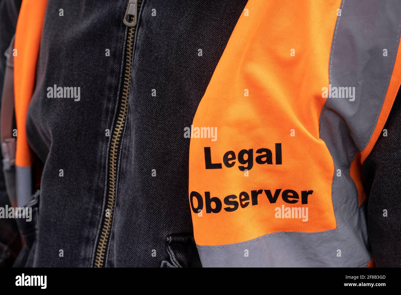 LONDON, UK - 03rd April 2021: A busy day of protests as England remains in Lockdown. Closeup of high visibility legal observer vest Stock Photo