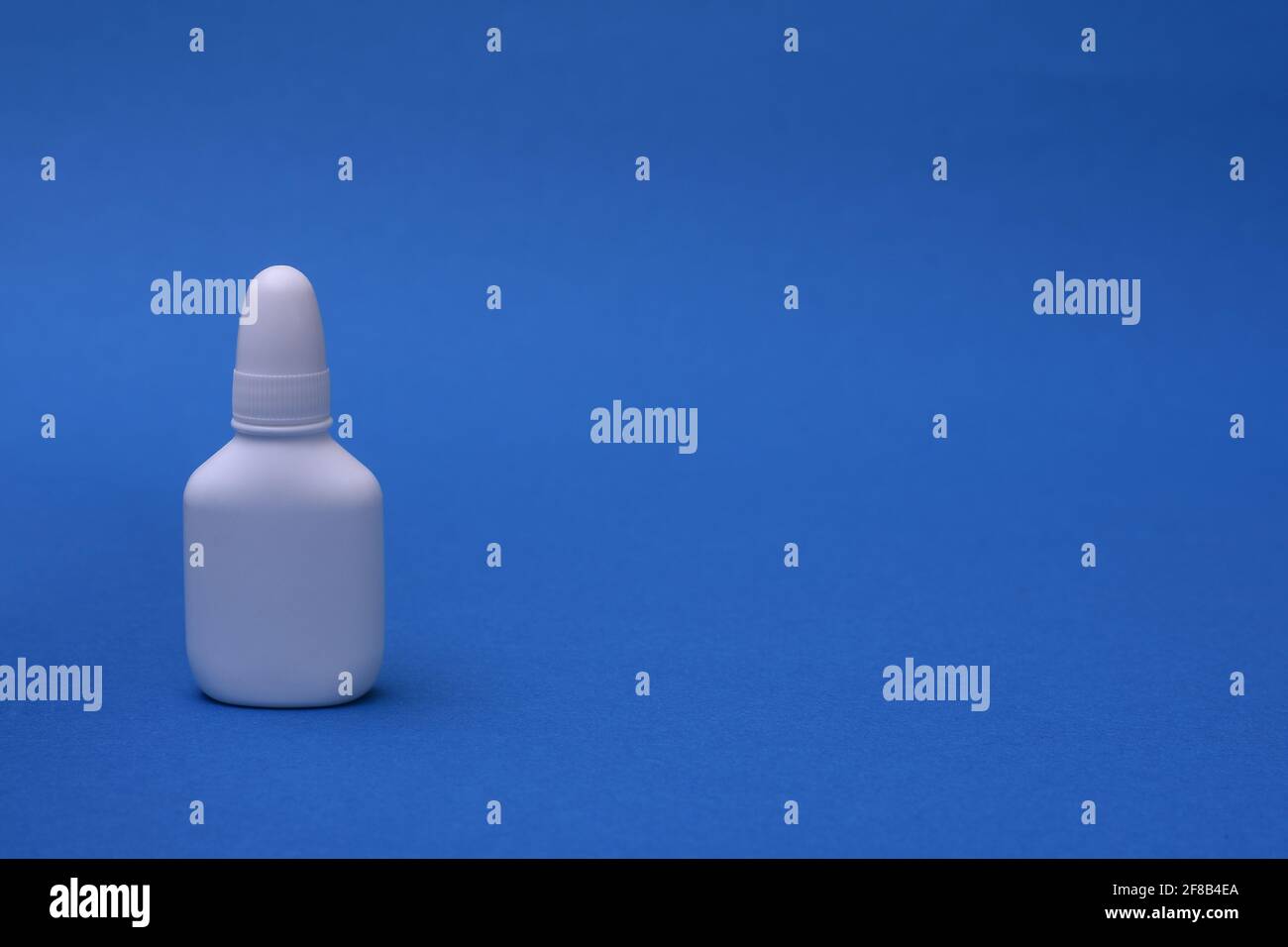 Nasal spray on a blue background. space for writing Stock Photo