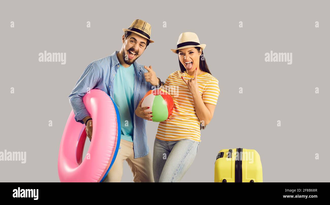 Portrait funky crazy couple with luggage beach accessory celebrate vacation time Stock Photo