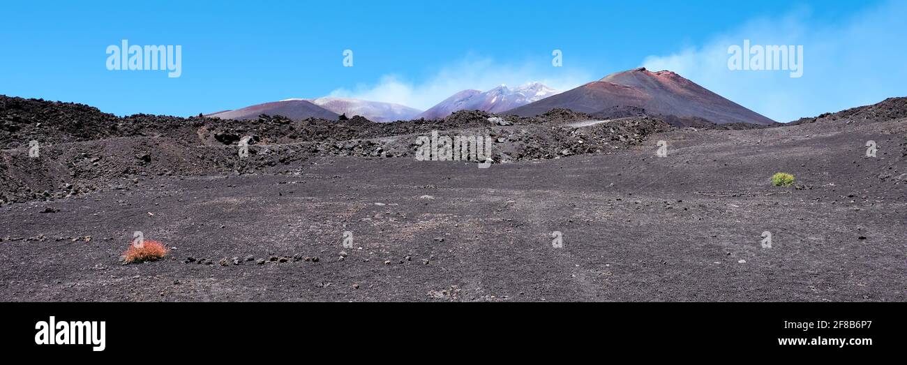 Mount Etna in Sicily near Catania, Tallest active volcano in Italy and whole Europe. Panoramic banner composition. Traces of volcanic activity, steam Stock Photo