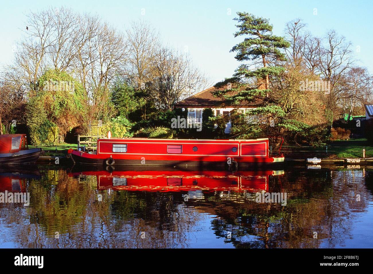 Bungalow and narrowboat on the River Lea Navigation near Springfield Park, Upper Clapton, North East London UK, in springtime Stock Photo