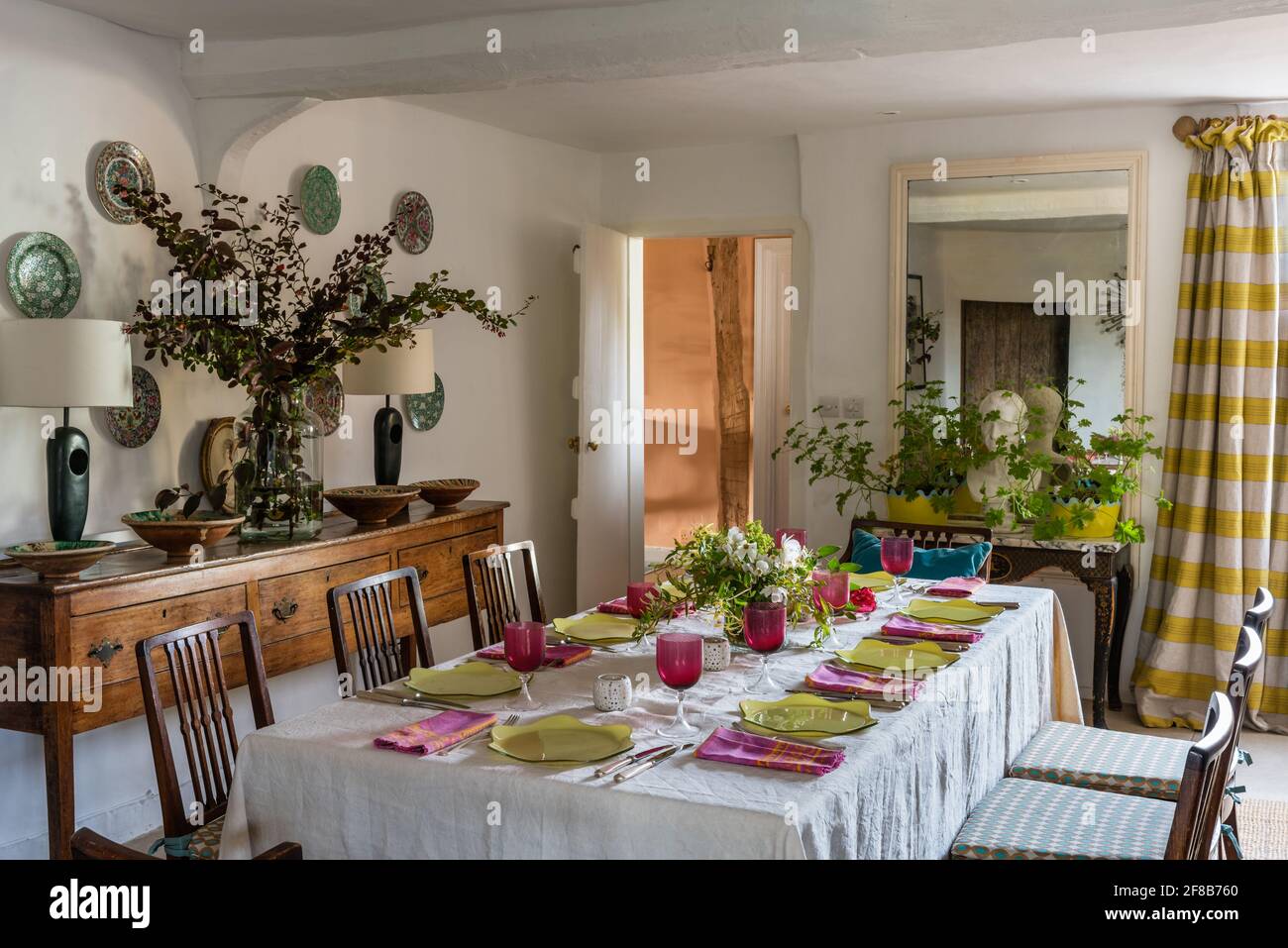 Table for eight in dining room with walls in 'Clean White', Grade II listed farmhouse, Suffolk Stock Photo