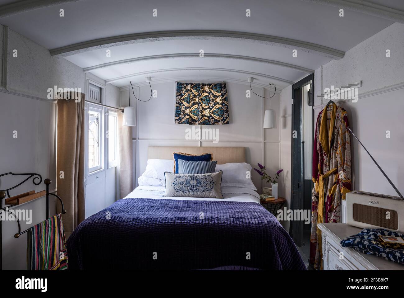 Double bed in repurposed Victorian railway carriage, West Sussex holiday home. Stock Photo