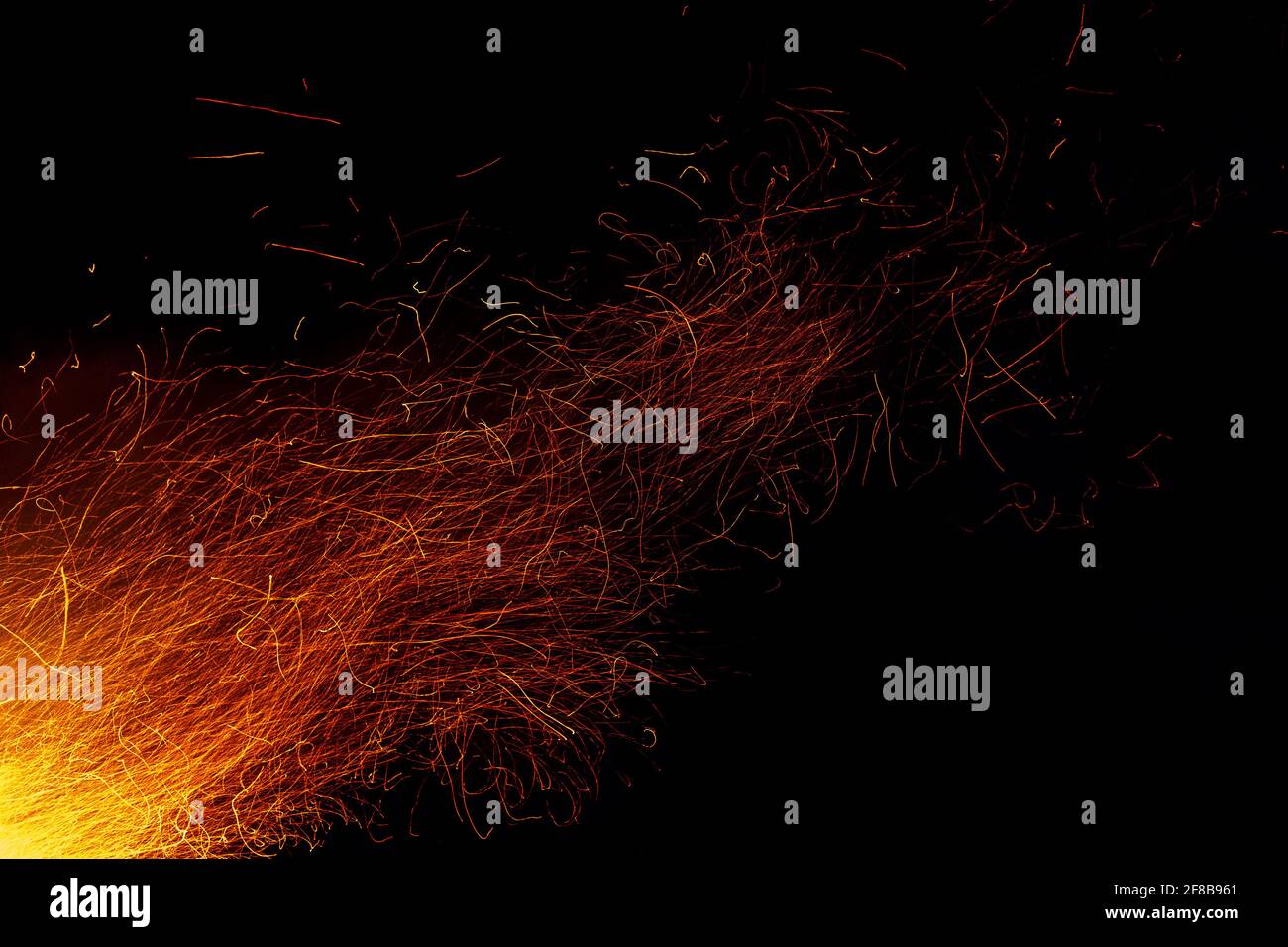 Trails of sparks from bonfire against night sky Stock Photo - Alamy