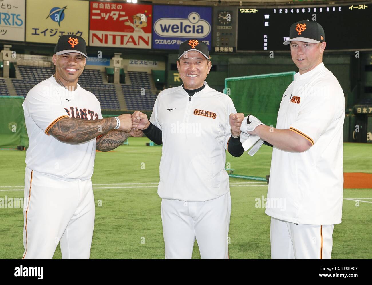 Tokyo, Japan. April 13, 2021: New Yomiuri Giants outfielder Eric Thames (L)  and first baseman Justin Smoak (R) pose for a photo with manager Tatsunori  Hara at Tokyo Dome on April 13