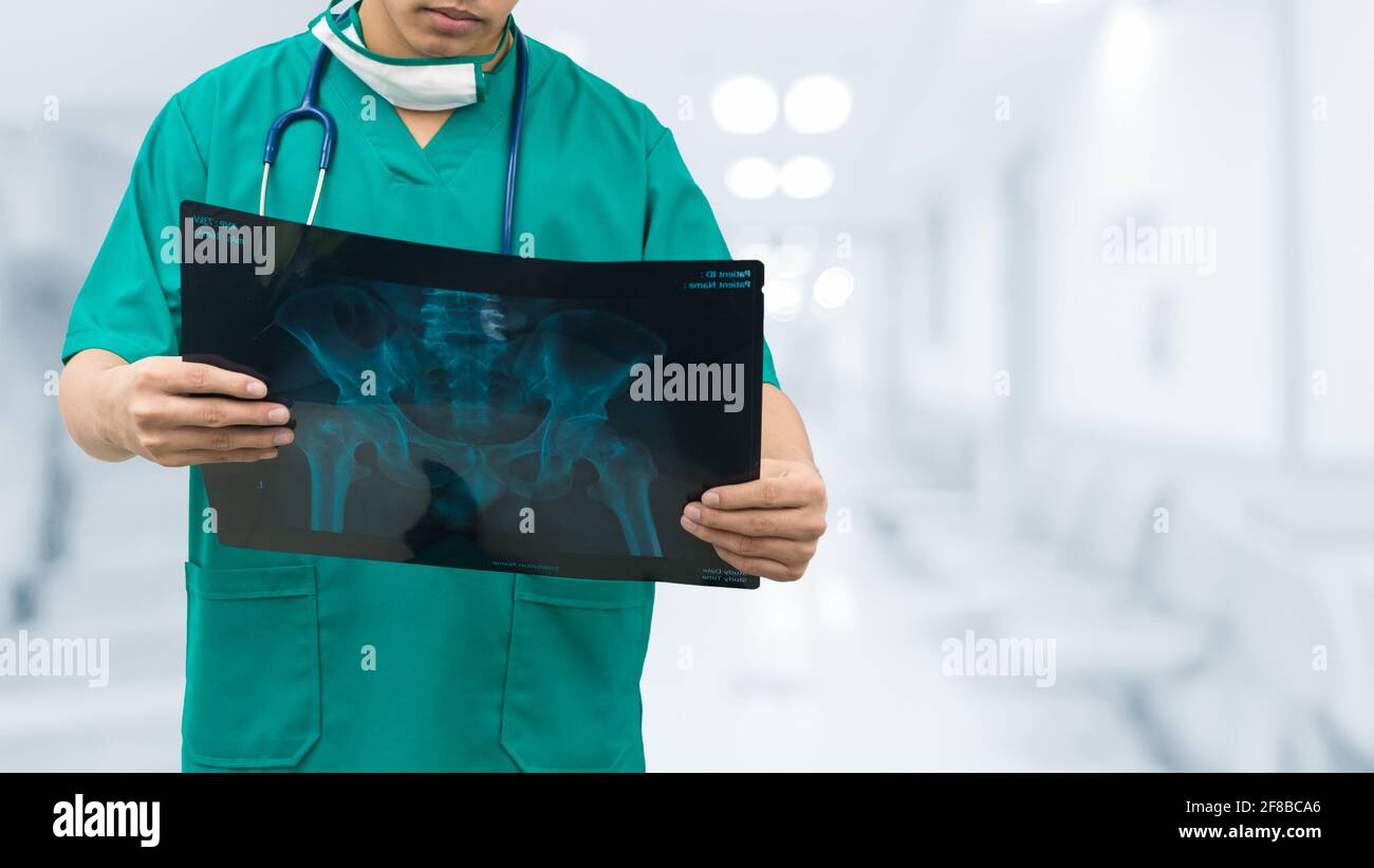 Surgical doctor examining xray film, diagnose patient 's waist bone. Surgery operation concept. Stock Photo