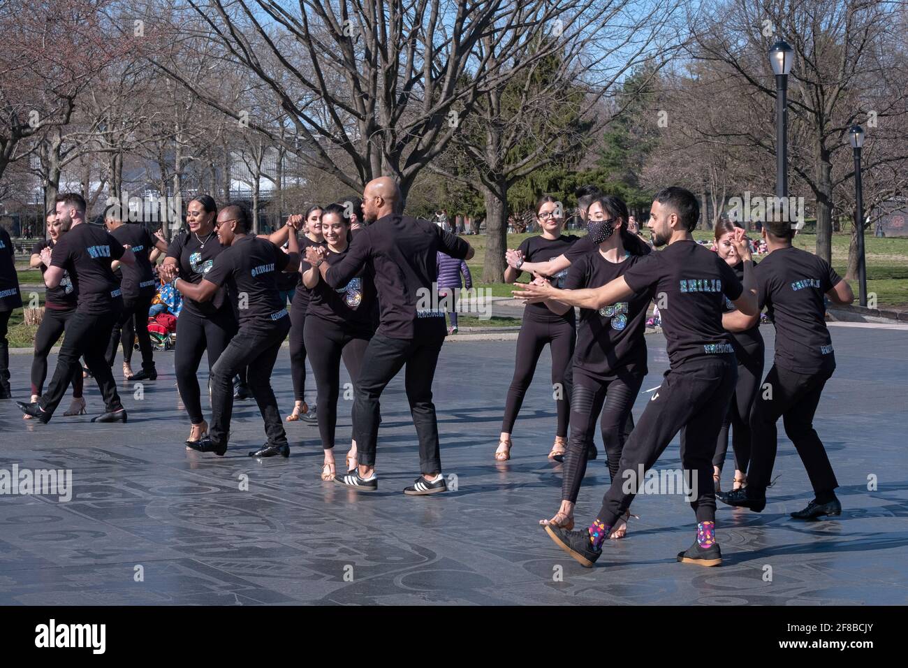 Dancers from the Cali Salsa Pal Mundo dance studio film a performance in public to publicize their school. In Flushing Meadows Corona Park in Queens Stock Photo