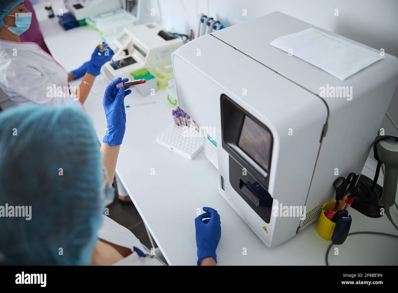 Lab Counts Experienced lab worker performing a complete blood count Stock Photo ...