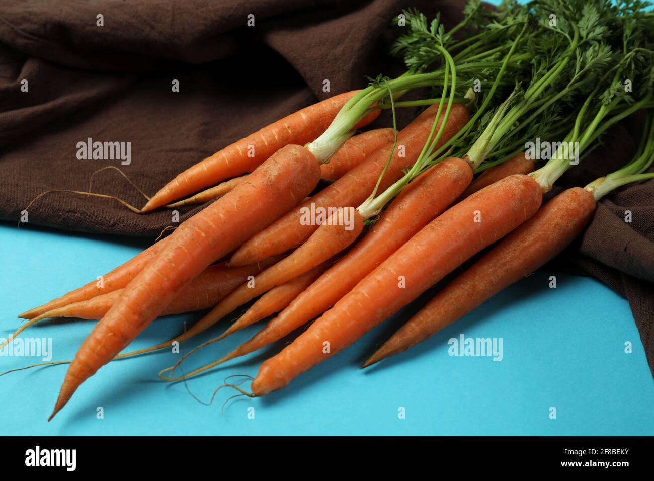 Kitchen towel with carrot on blue background Stock Photo