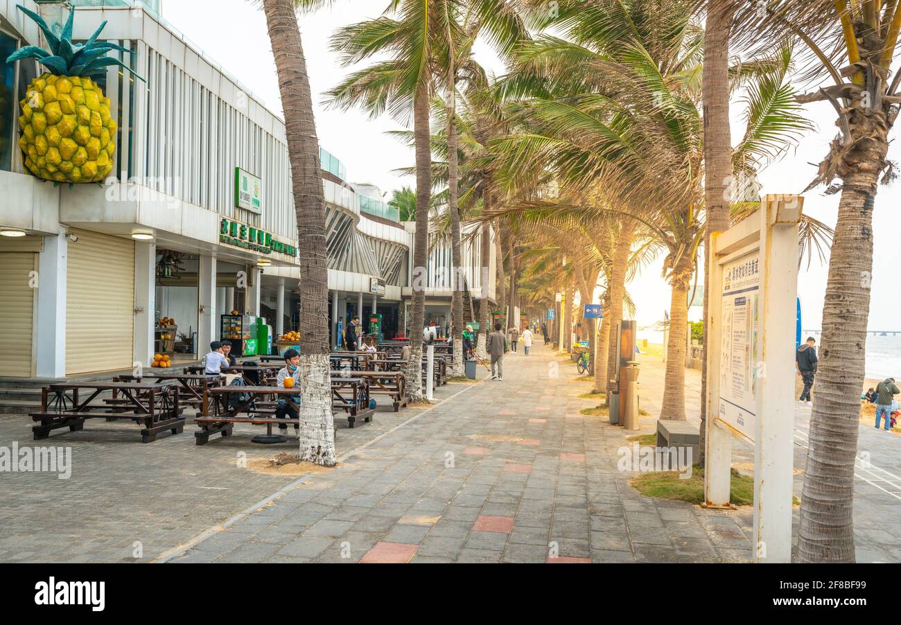 Haikou China , 23 March 2021 : Haikou holiday beach resort beachside with shops and terrace with people in Haikou Hainan China Stock Photo