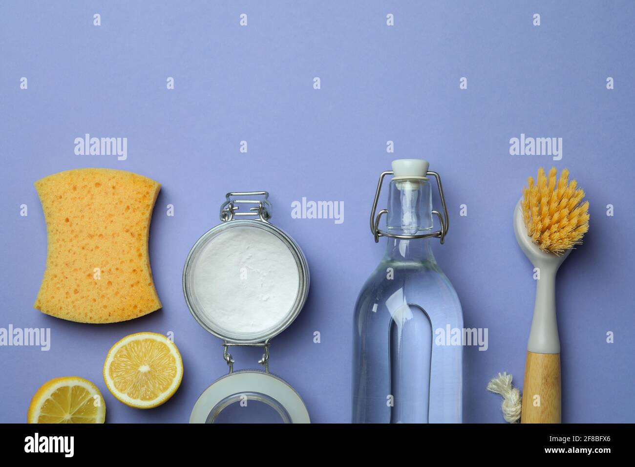 Flat lay with cleaning tools on violet background Stock Photo - Alamy