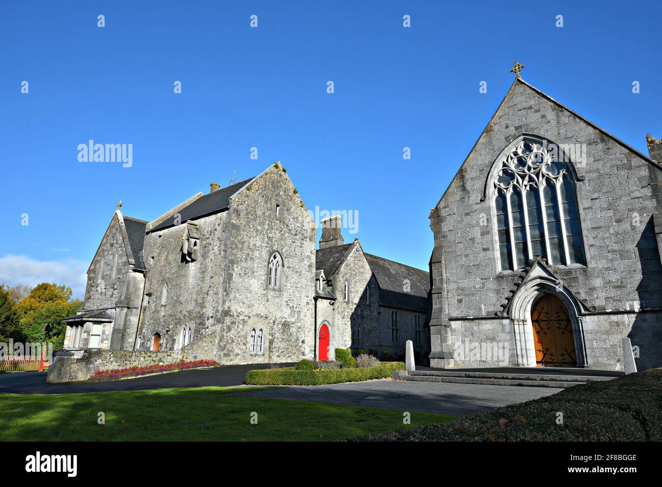 Landscape with scenic view of the Medieval Gothic Revival style Holy Trinity Abbey in Adare, County Limerick Ireland. Stock Photo