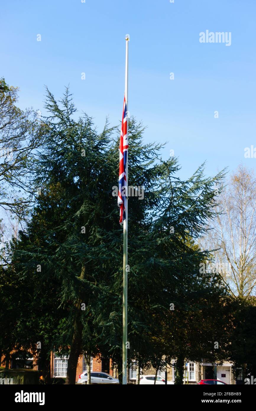 The Union Flag flys at half mast during the mourning period for HRH Prince Phillip, the Duke of Edinburgh. April 2012. St Wulframs Church, Grantham, L Stock Photo