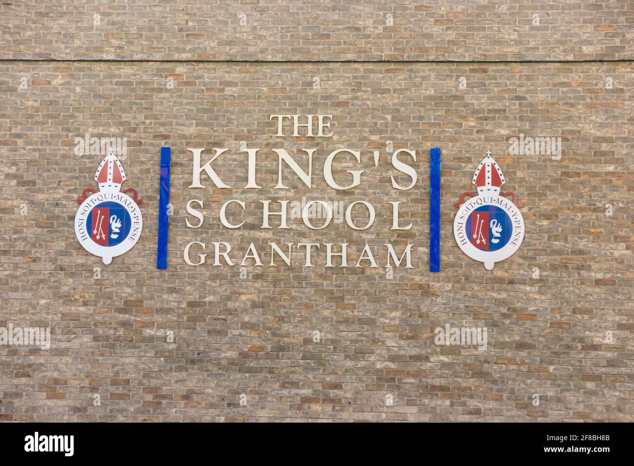The Kings School Grantham, grammar school logo and sign on a brick wall. Grantham, Lincolnshire, England Stock Photo